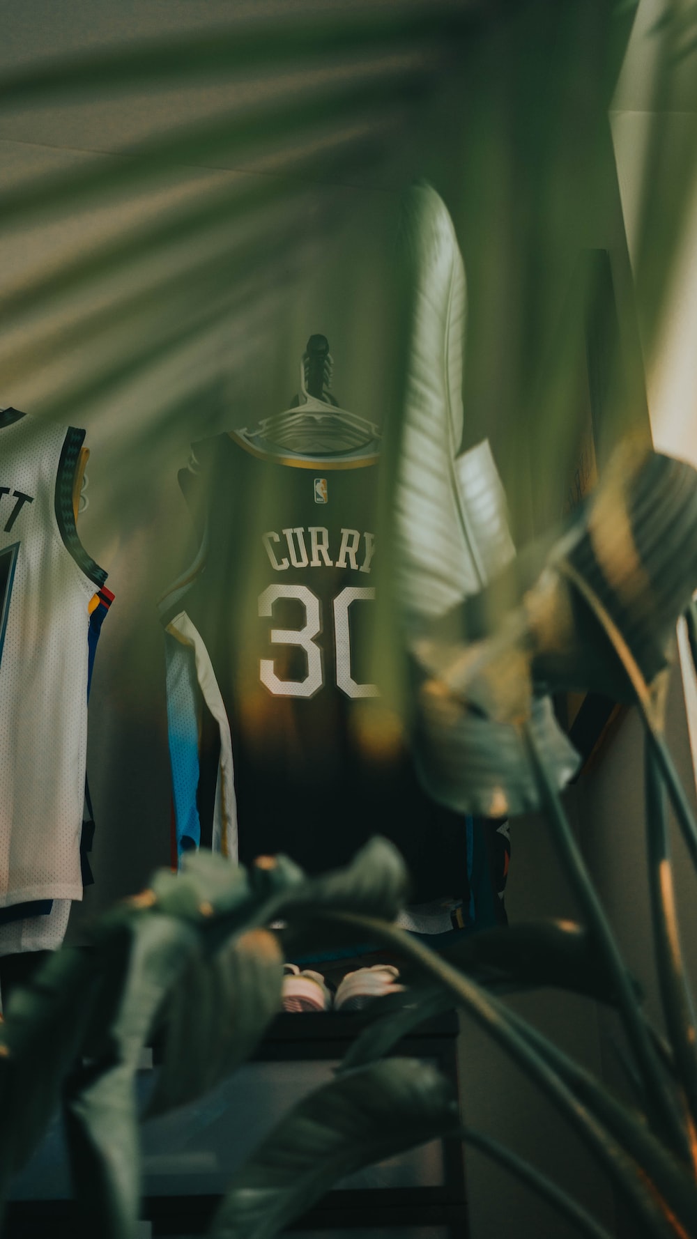 a basketball jersey on a table next to a plant