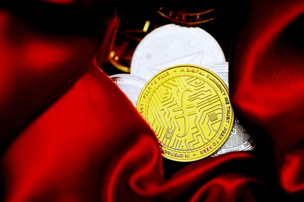 a bitcoin sitting on top of a red cloth