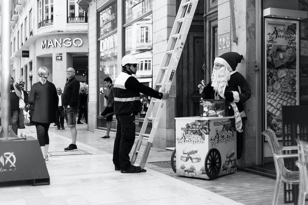 a black and white photo of a man dressed as santa