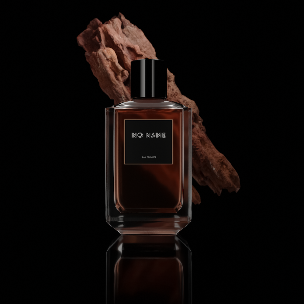 a bottle of perfume with a rock in the background
