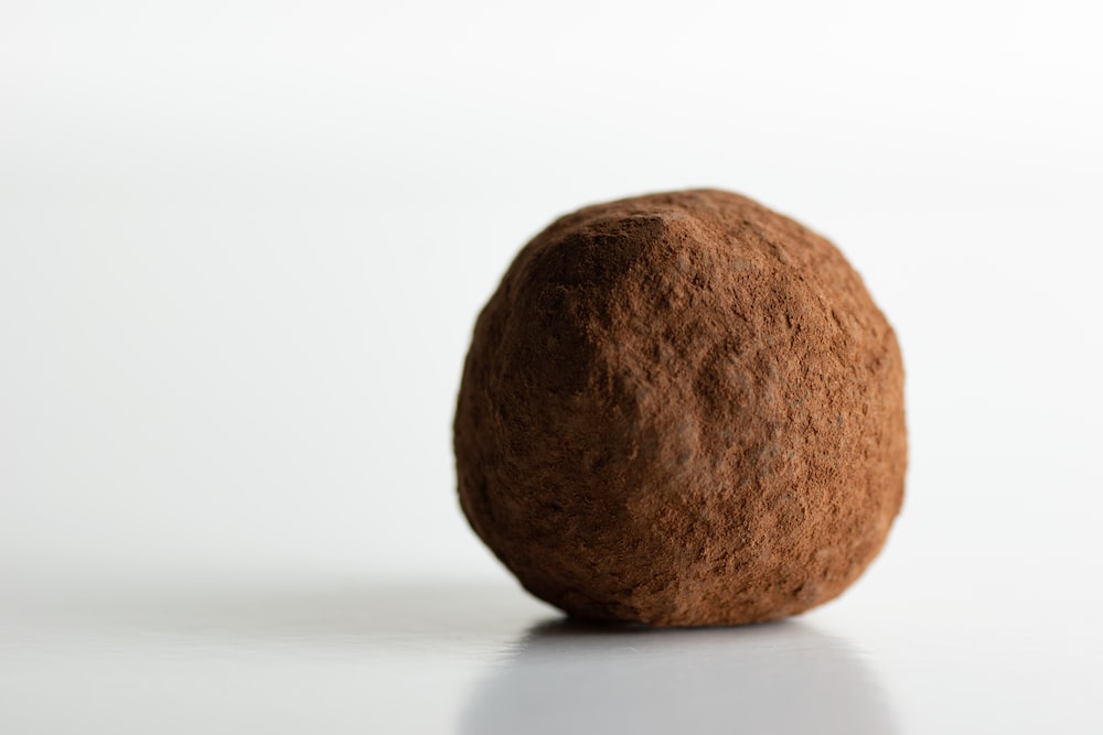 a brown rock sitting on top of a white table