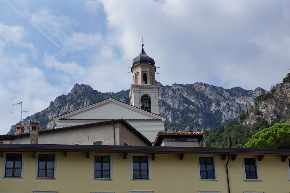 a building with a tower and a mountain in the background