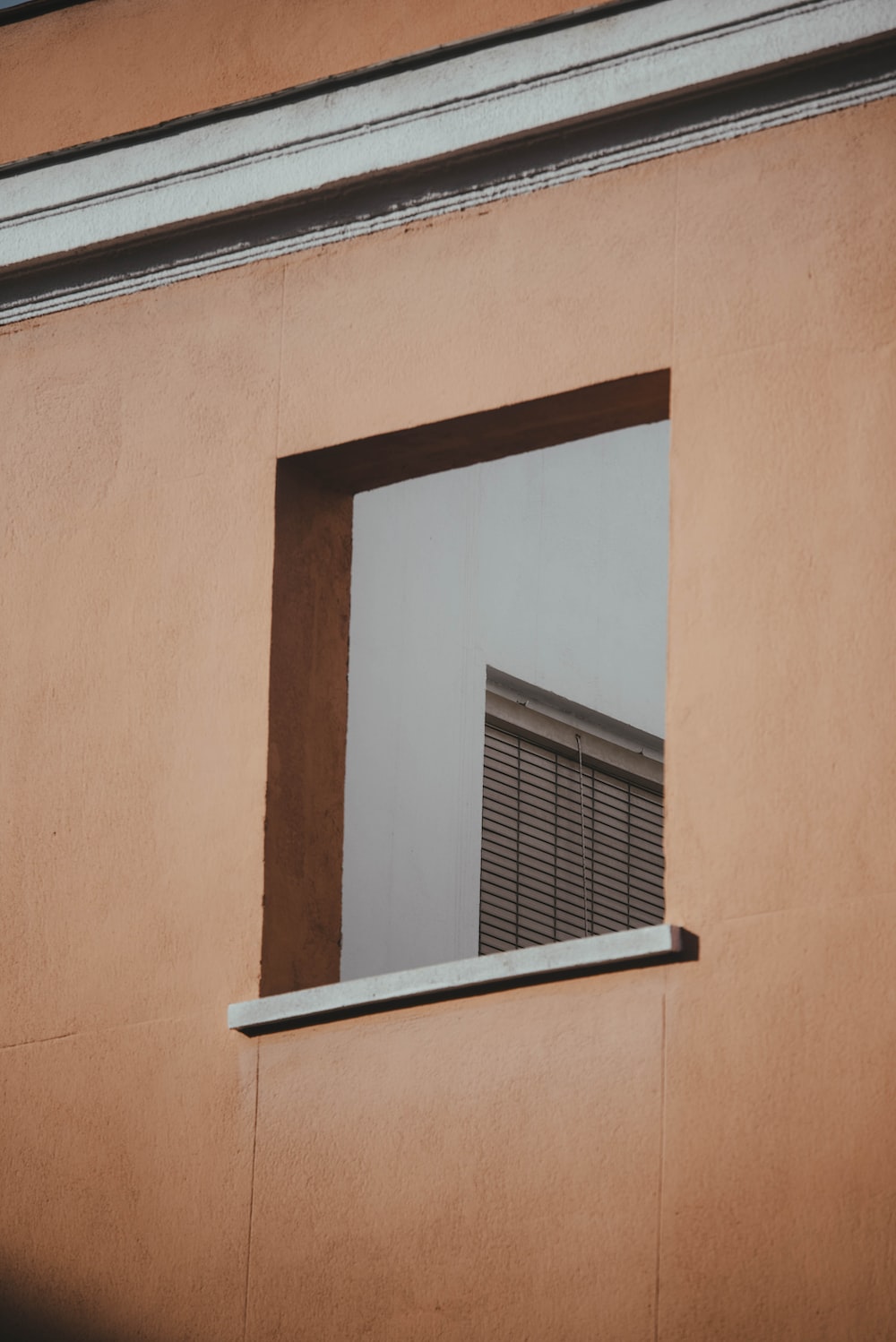 a building with a window that has blinds in it