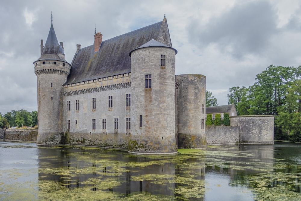 a castle with towers and a moat