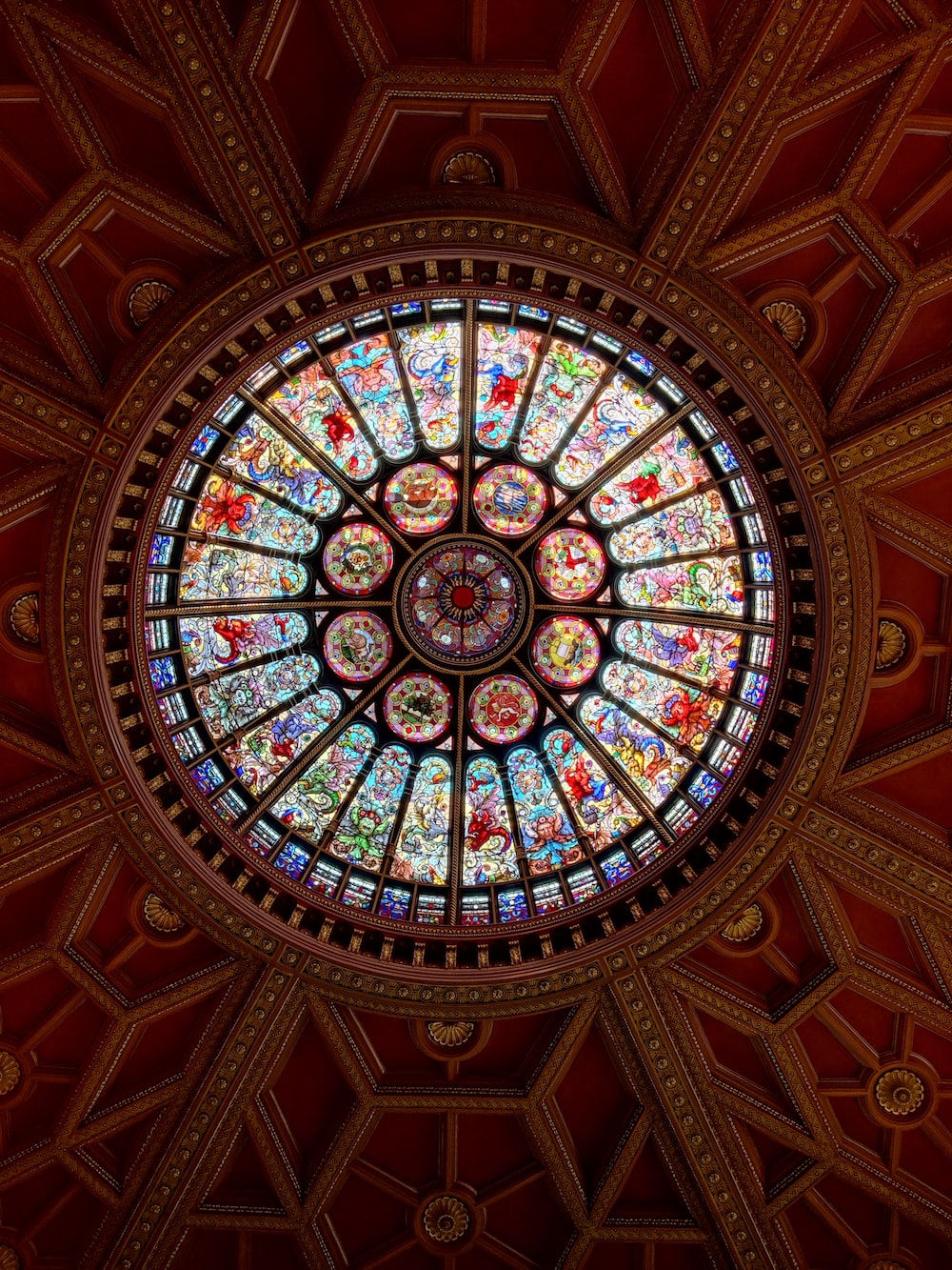 a circular stained glass window in the ceiling of a building