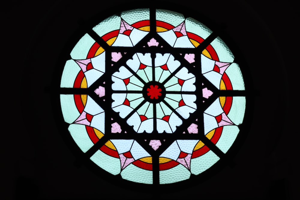 a circular stained glass window with hearts on it