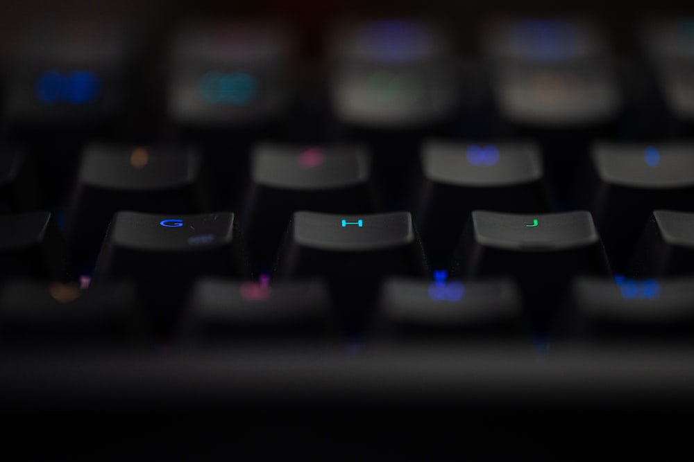 a close up of a black keyboard with blue keys