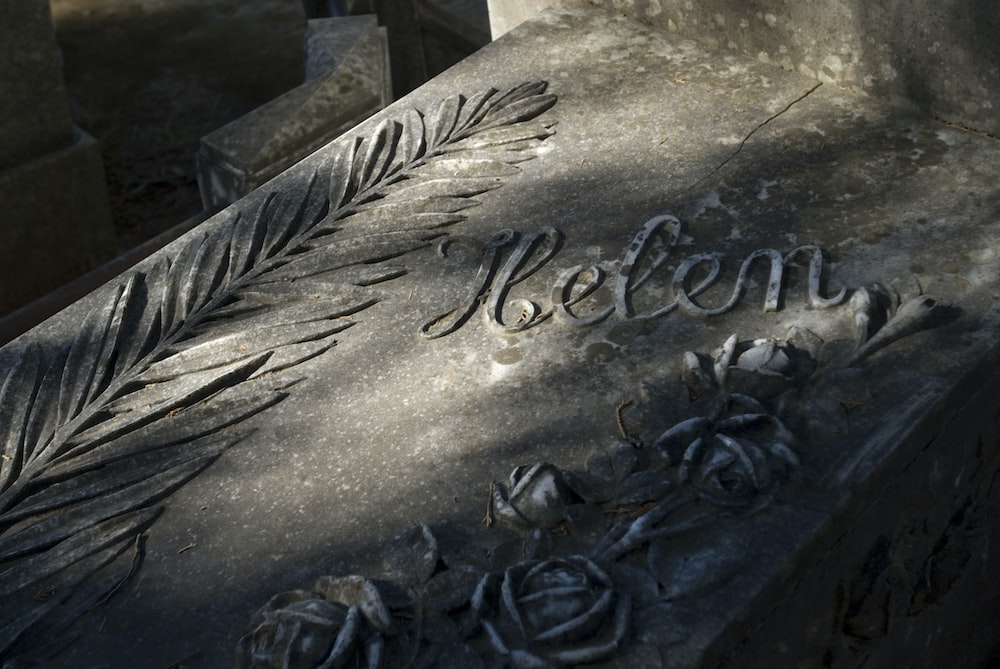 a close up of a grave with writing on it