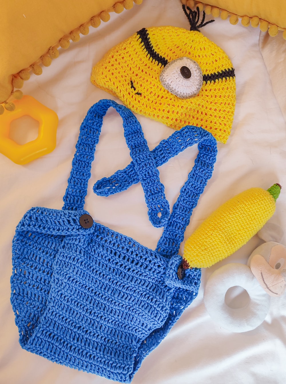 a crocheted bag, banana, and hat on a bed