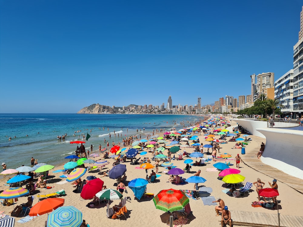 a crowded beach with umbrellas