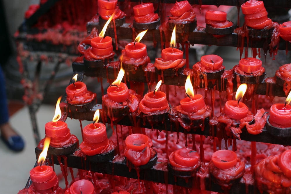 a display of red candles with red wax on them