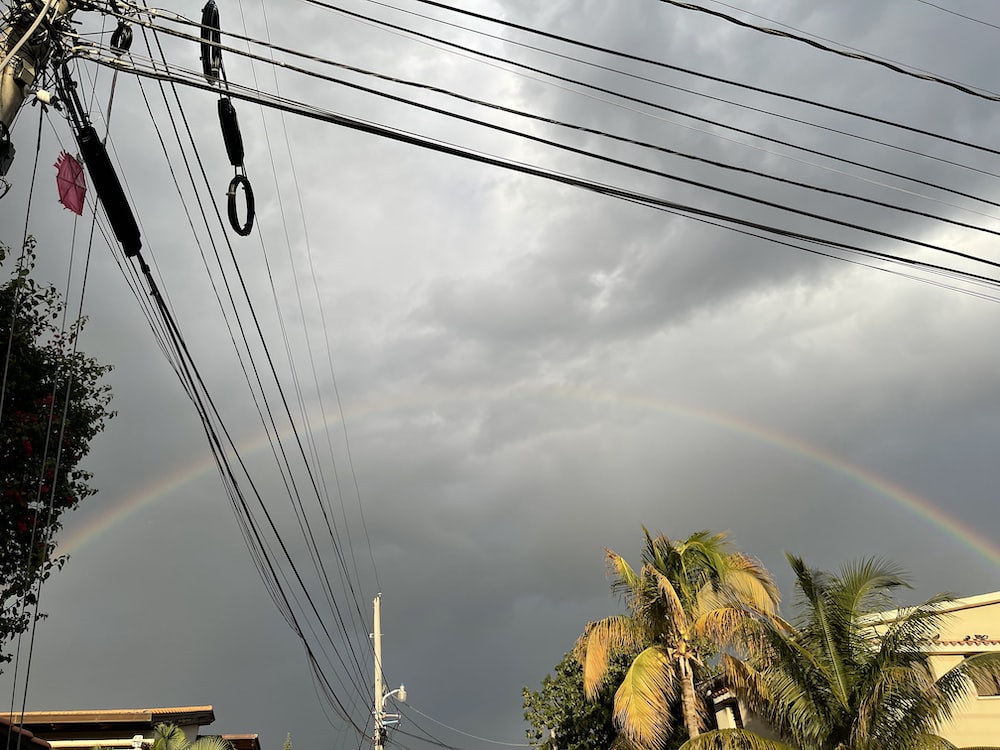 a double rainbow is seen over a city street