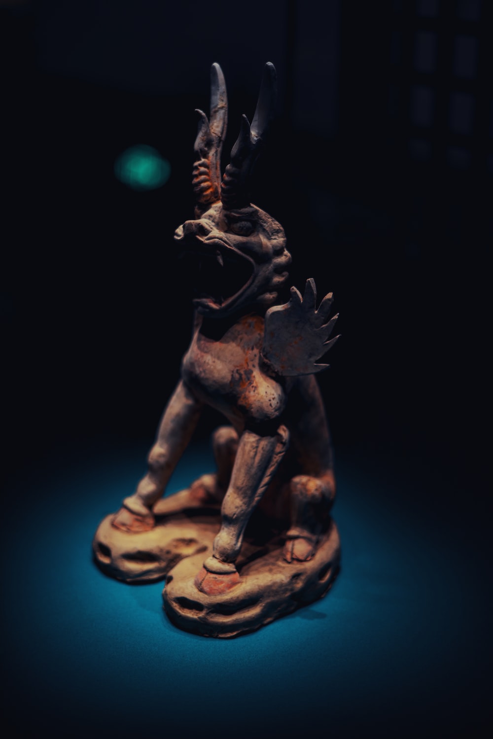 a figurine of an egyptian god on a blue background