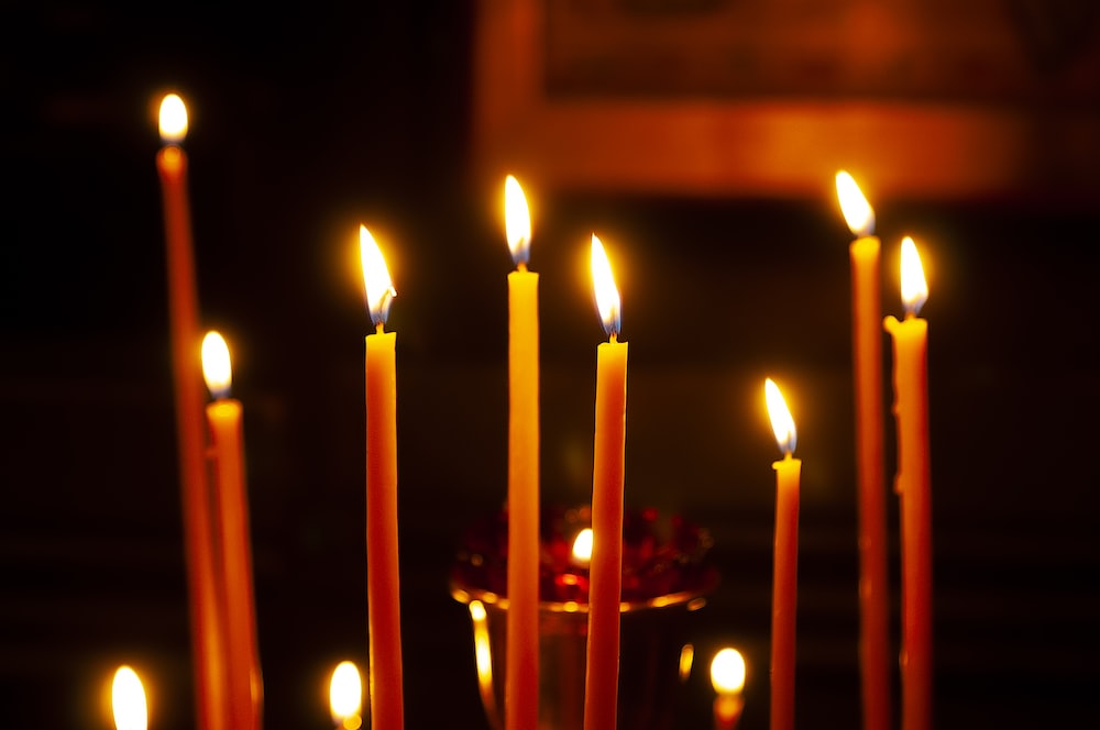 a group of lit candles in a church