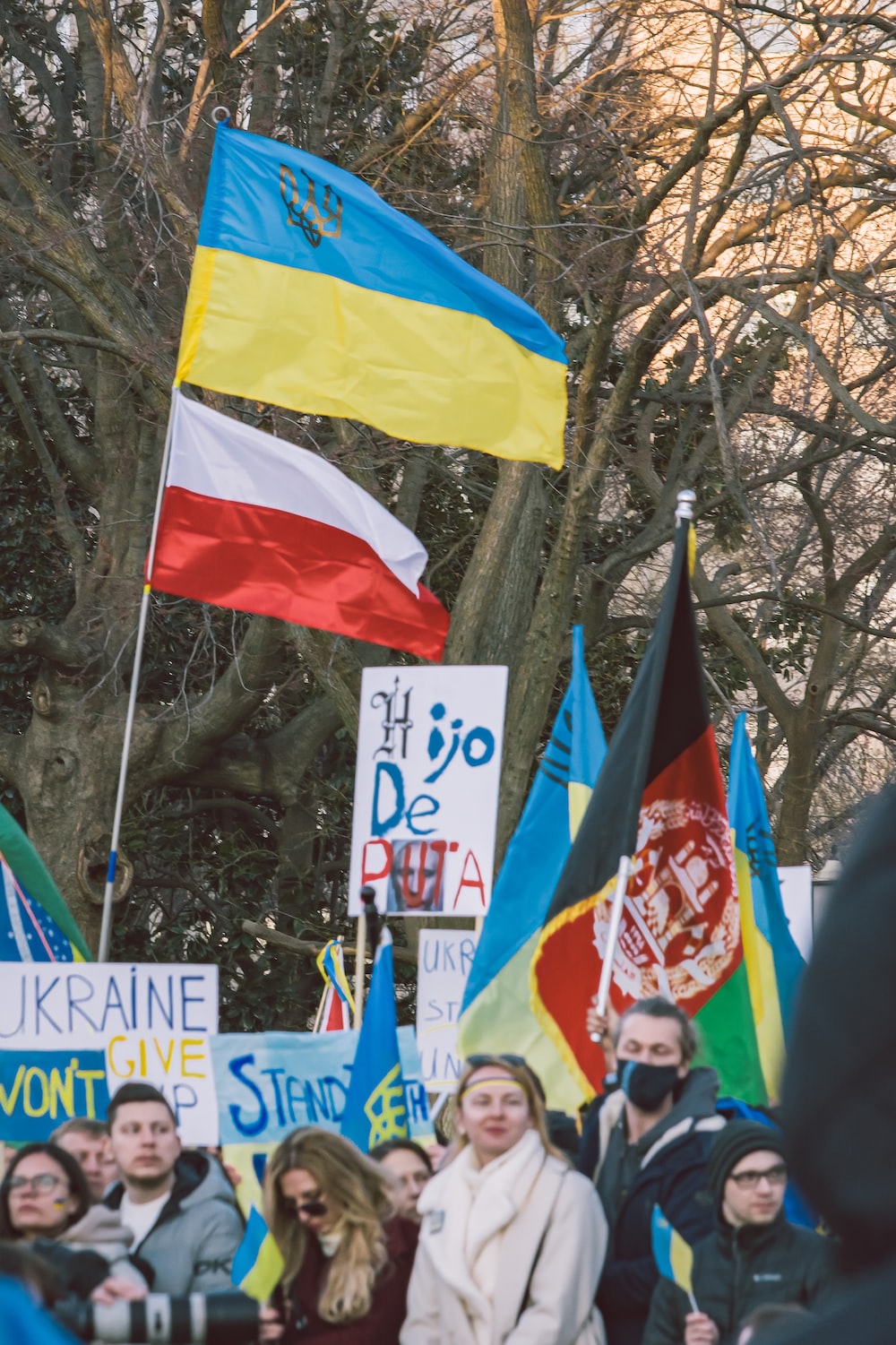 a group of people holding flags and banners