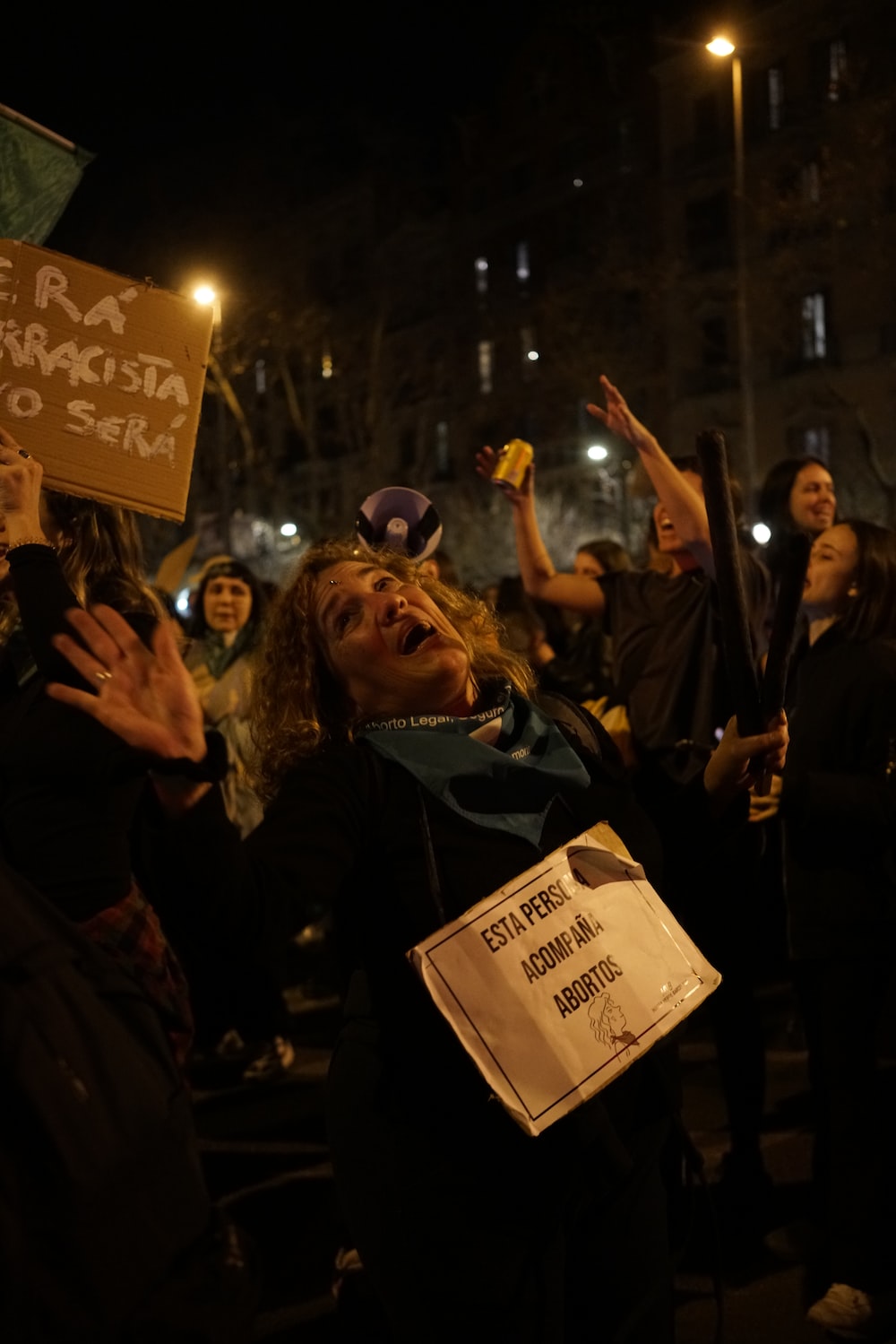 a group of people holding up signs at night