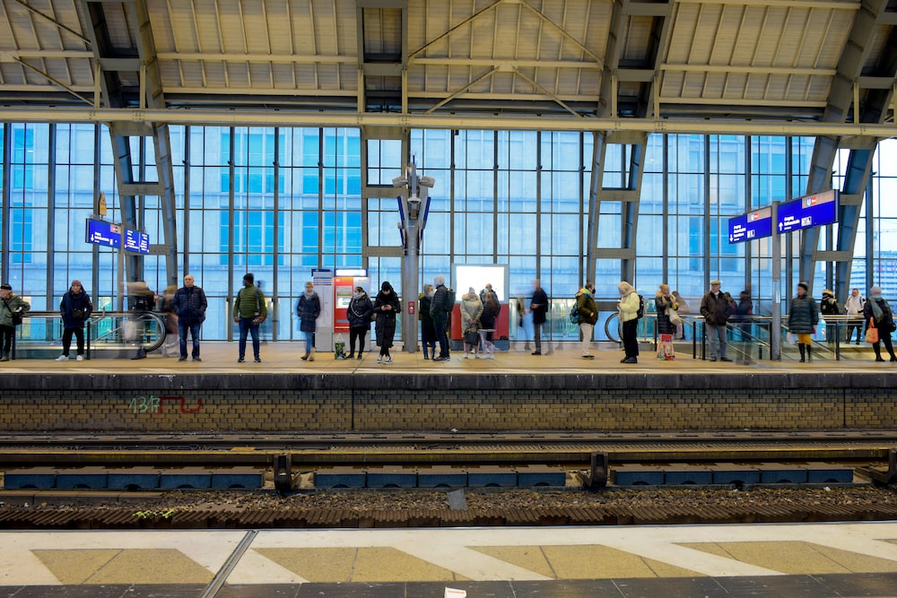 a group of people waiting at a train station