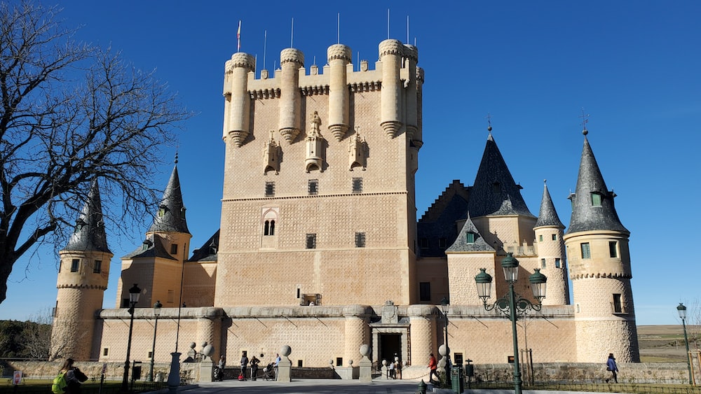a large castle with towers and turrets on a sunny day