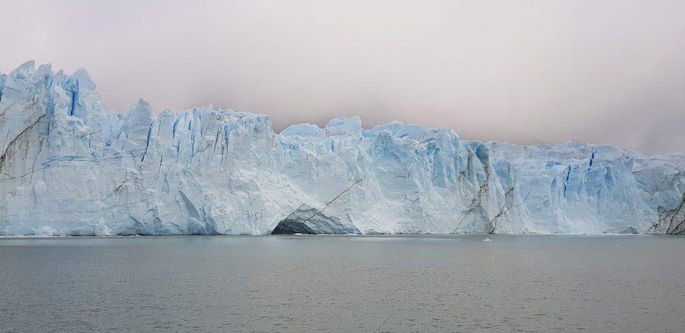 a large iceberg towering over a body of water