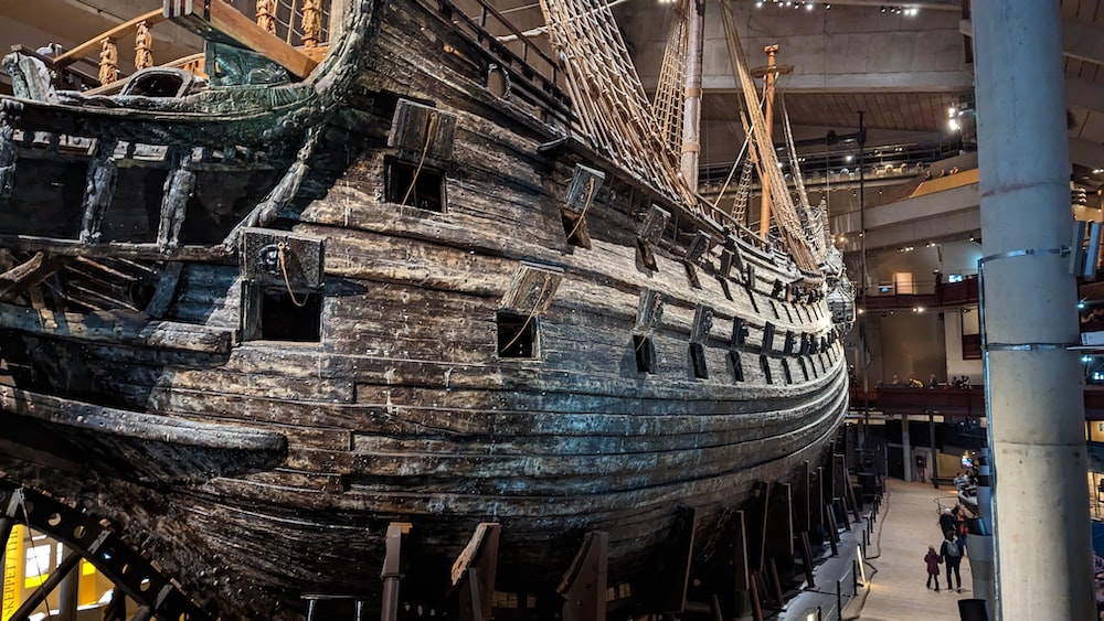 a large wooden boat is on display in a museum