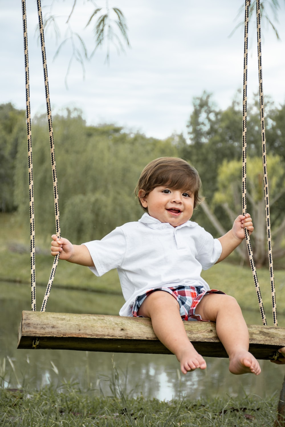 a little boy that is sitting on a swing