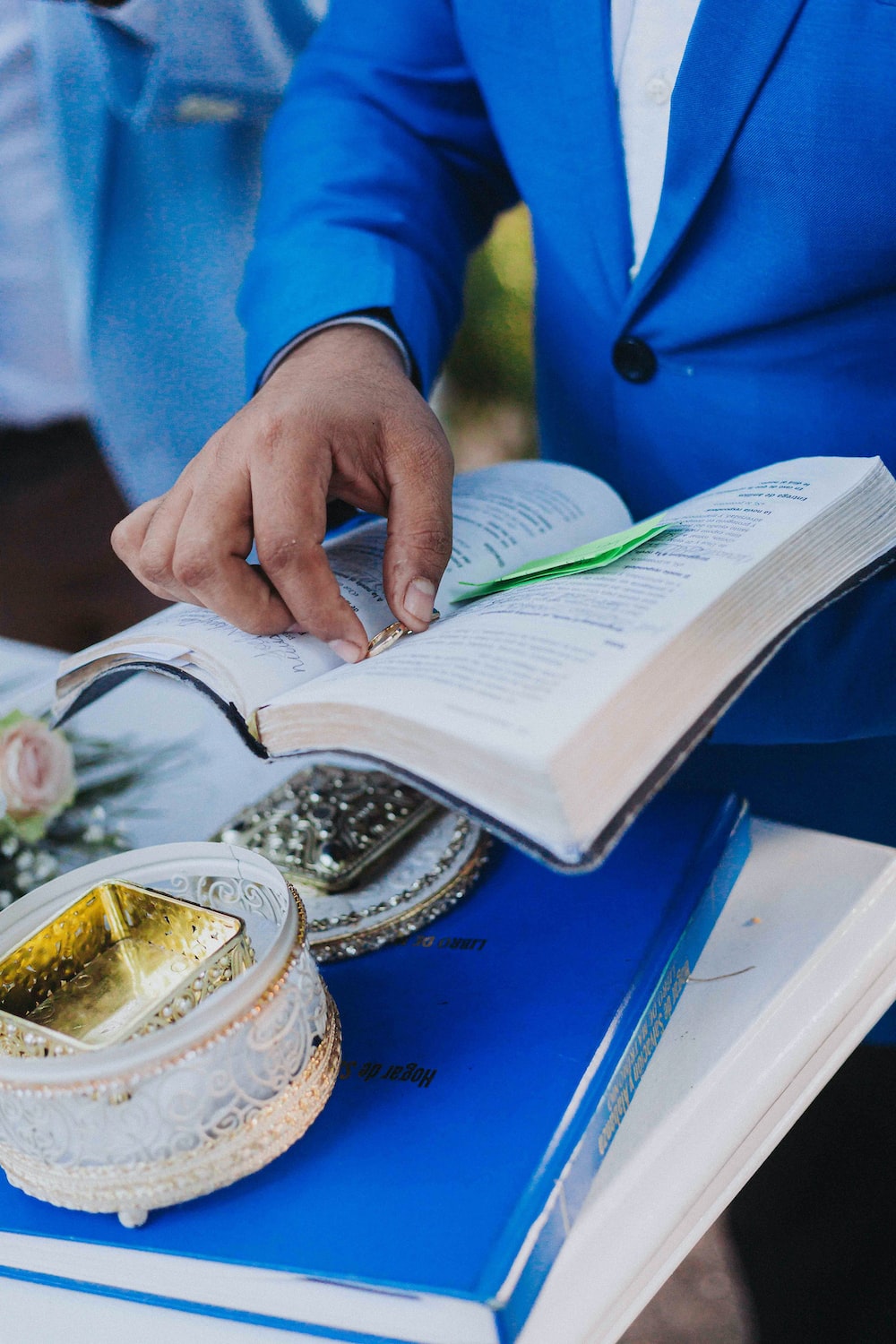 a man in a blue suit is reading a book