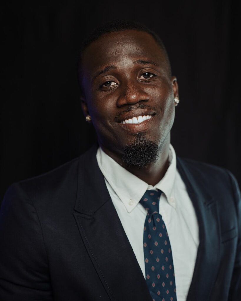 a man in a suit and tie smiling