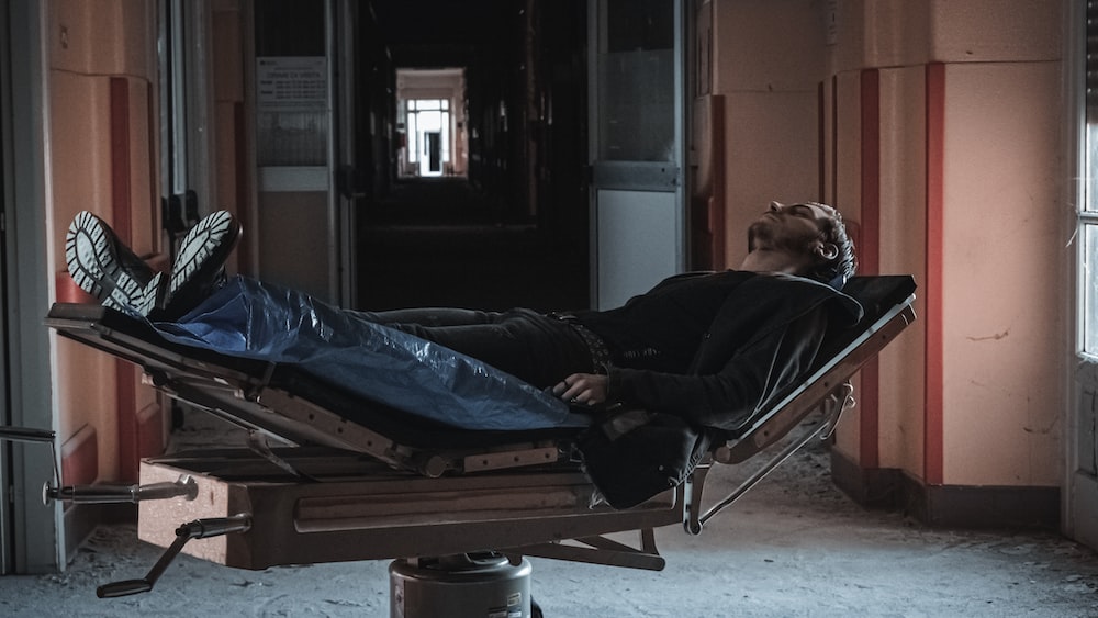 a man laying on top of a hospital bed