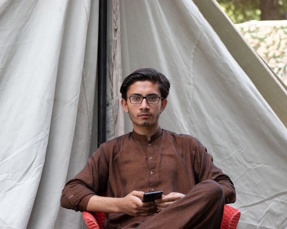 a man sitting in a tent