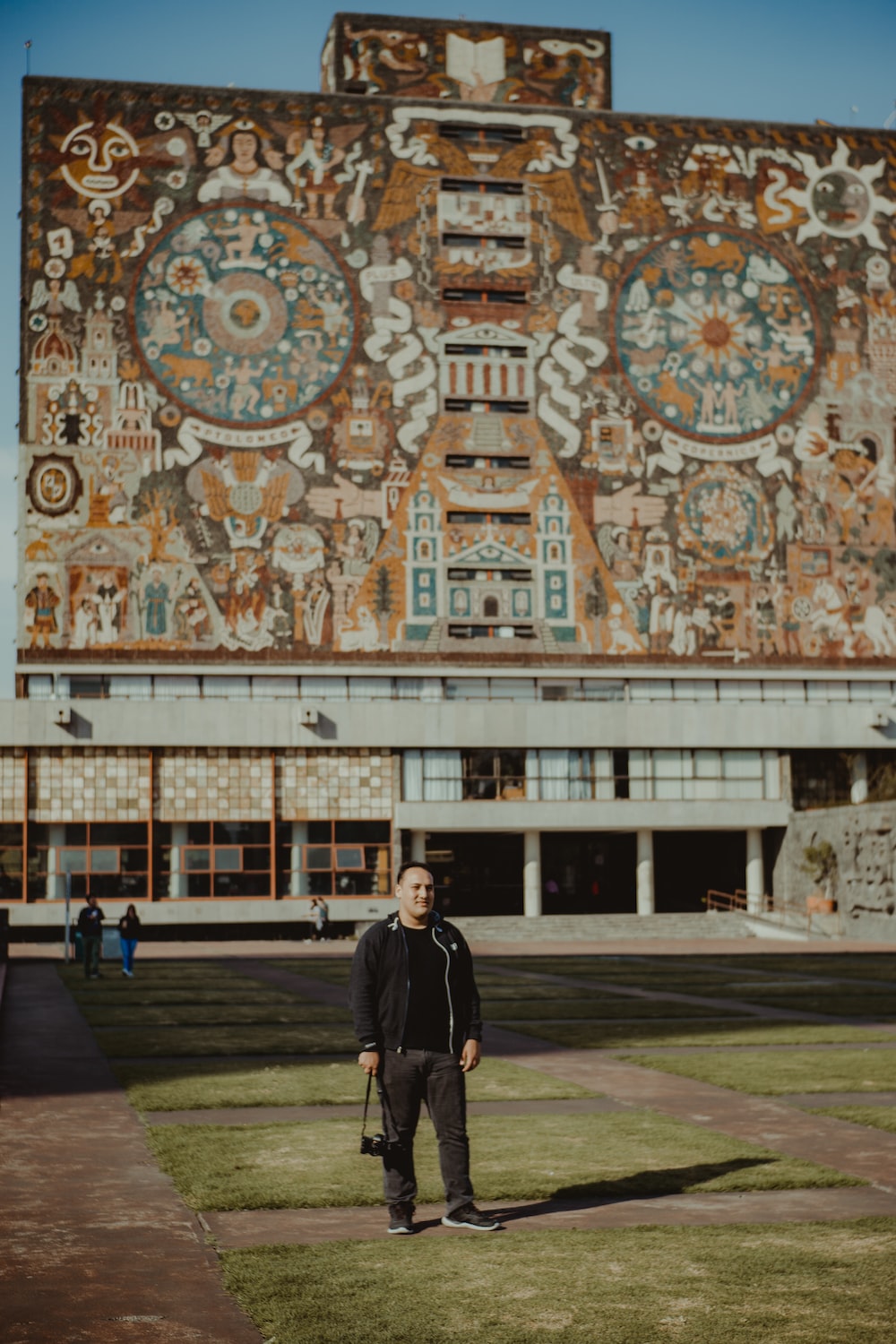 a man standing in front of a large building