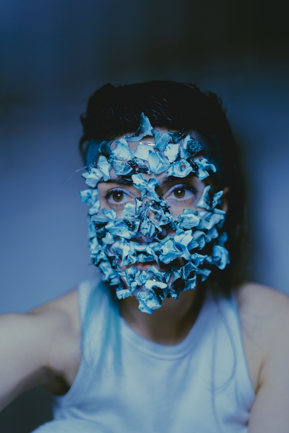 a man with a face mask covered in blue flowers