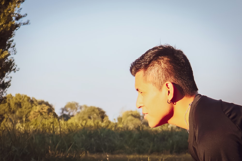 a man with earphones in a field
