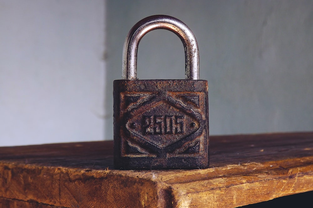a metal padlock on a wooden table