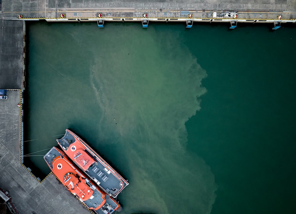 an aerial view of a boat docked at a dock