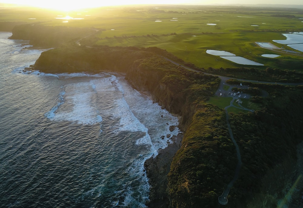an aerial view of a golf course next to the ocean