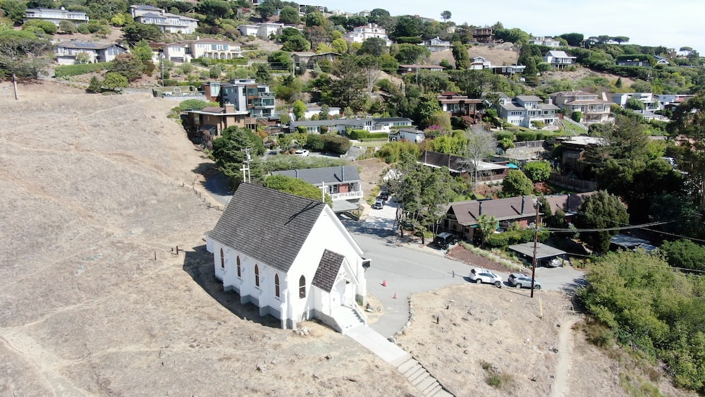 an aerial view of a small white church