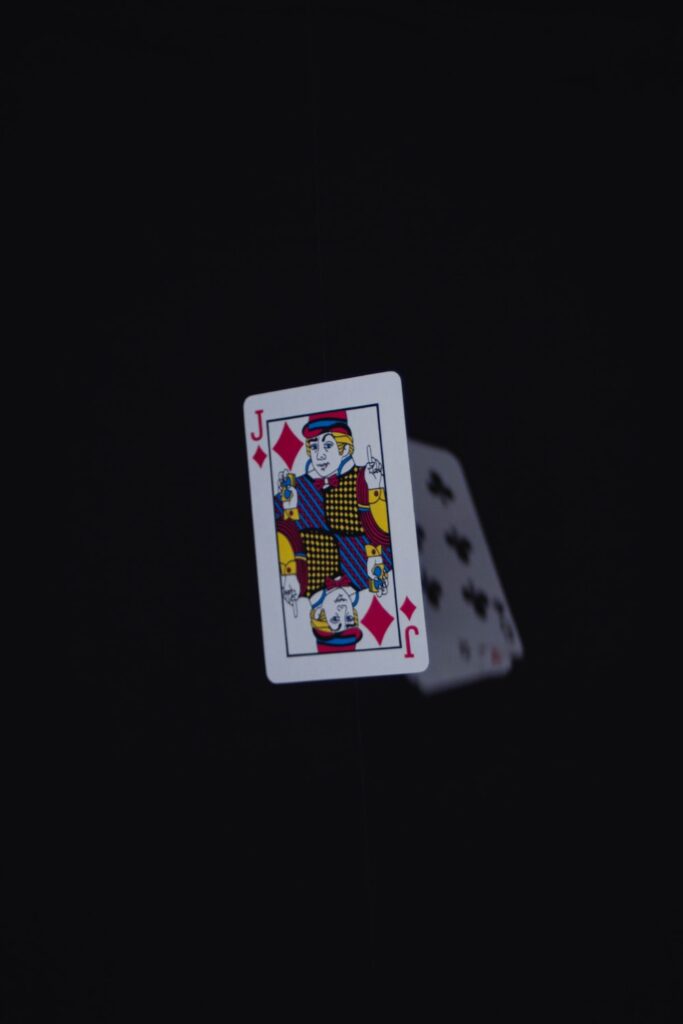 a pair of playing cards in the dark
