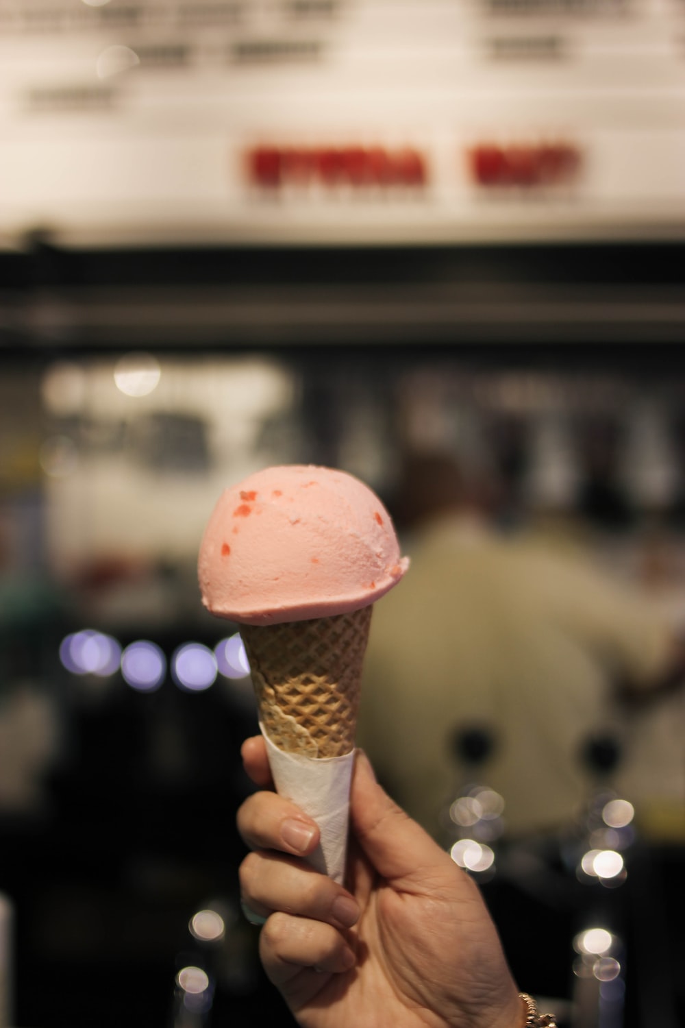 a person holding an ice cream cone