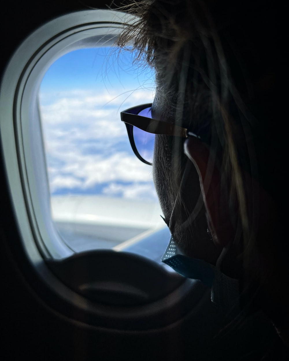 a person looking out of an airplane window
