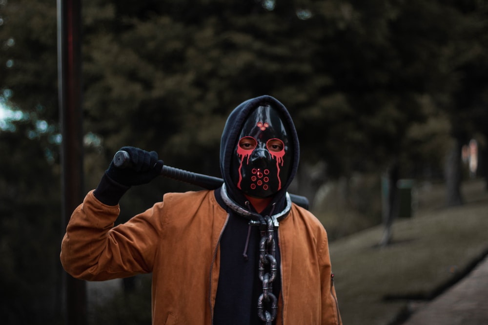 a person wearing a mask and holding a baseball bat