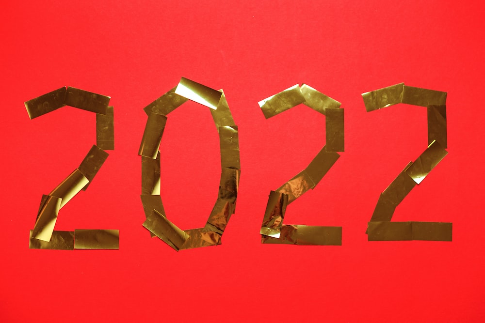 a red background with the numbers 2012 made out of gold foil