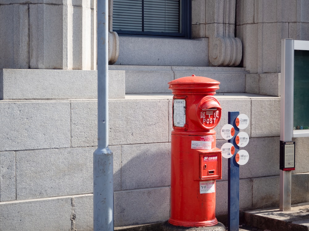 a red fire hydrant next to a building
