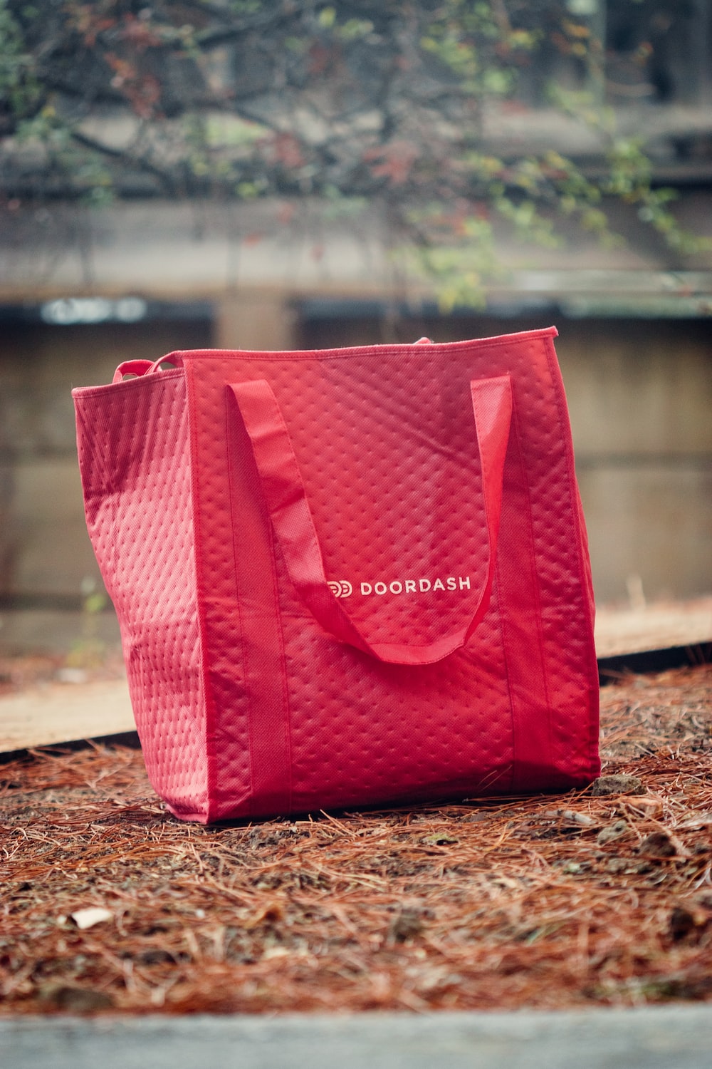 a red shopping bag sitting on the ground