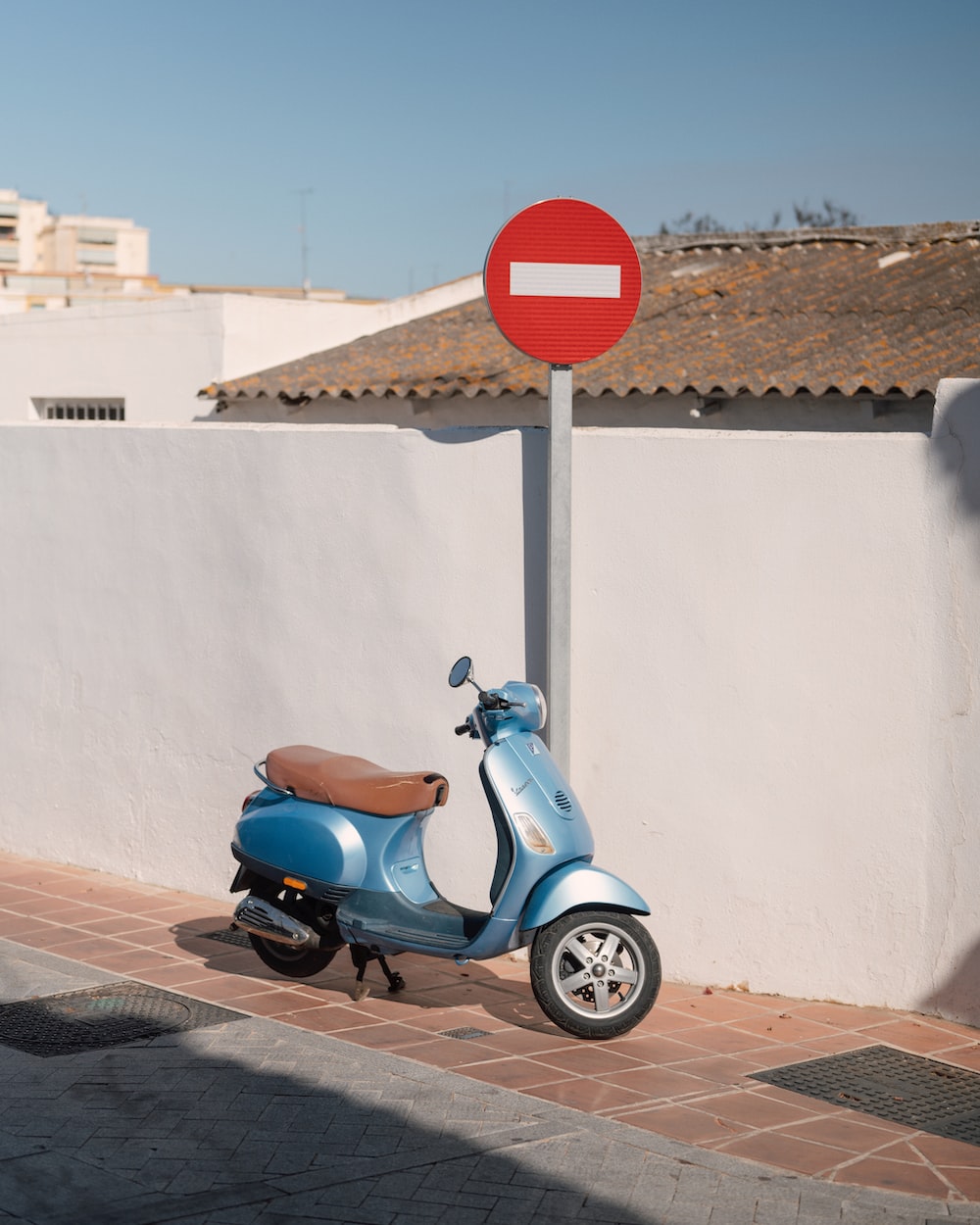 a scooter parked next to a sign