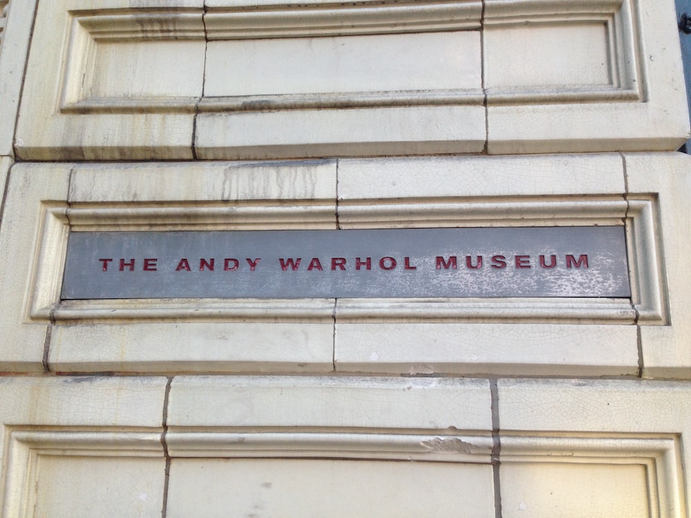 a sign on the side of a building that says the andy warhol museum