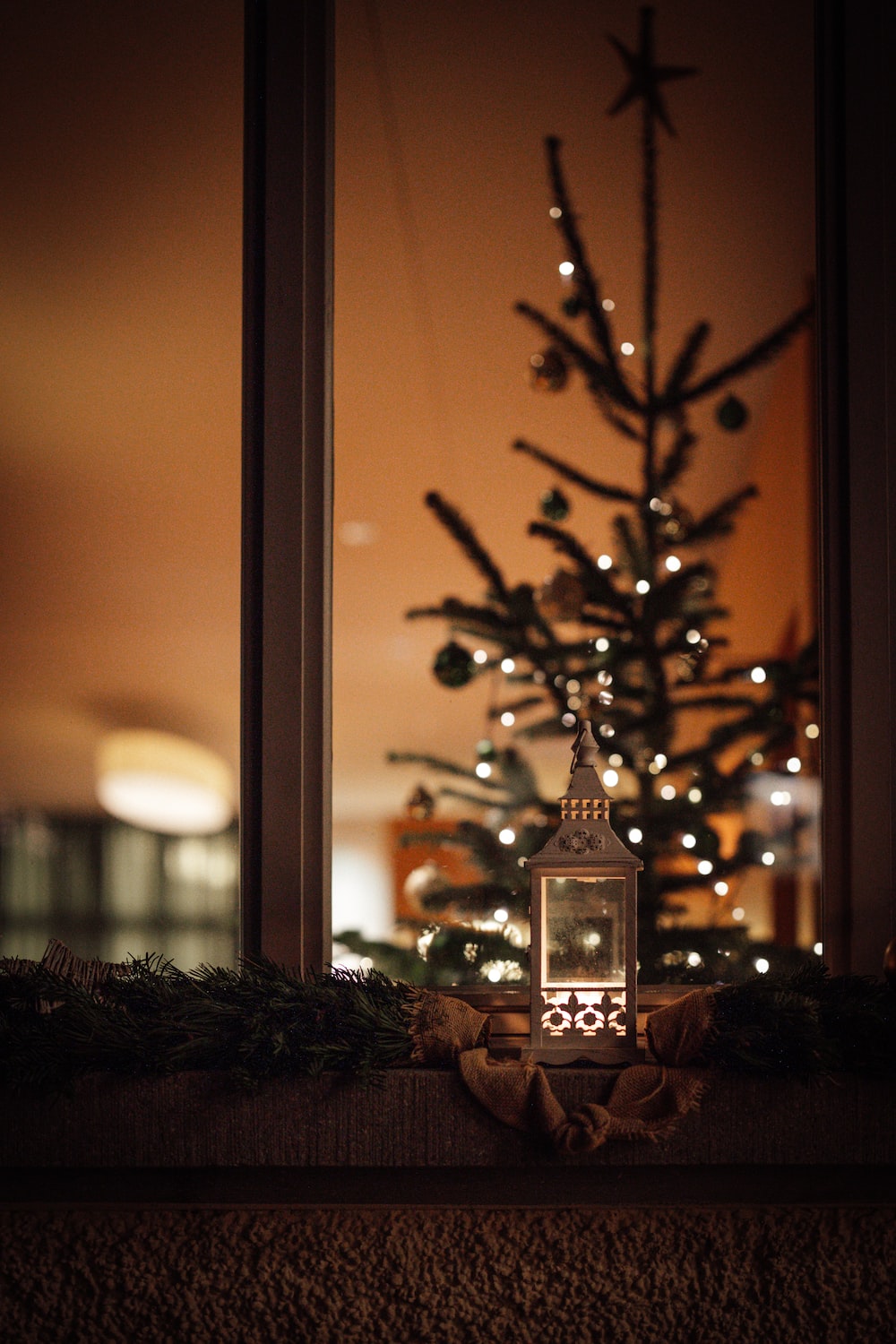 a small christmas tree in front of a window