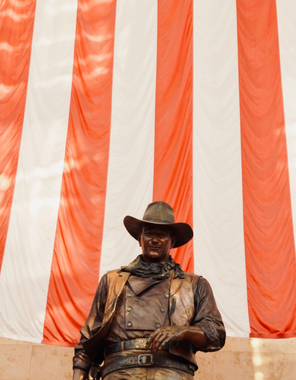 a statue of a man wearing a cowboy hat