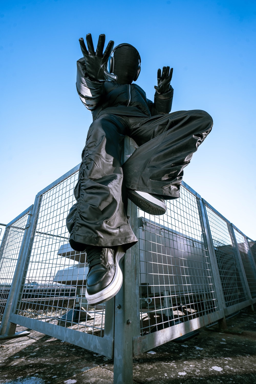 a statue of a person on a metal pole