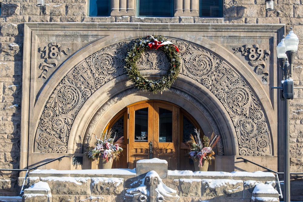 a stone building with a wreath on the front door