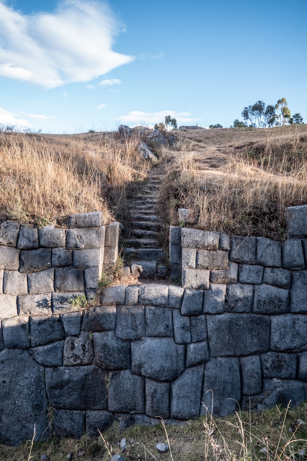 a stone wall with steps leading up to it